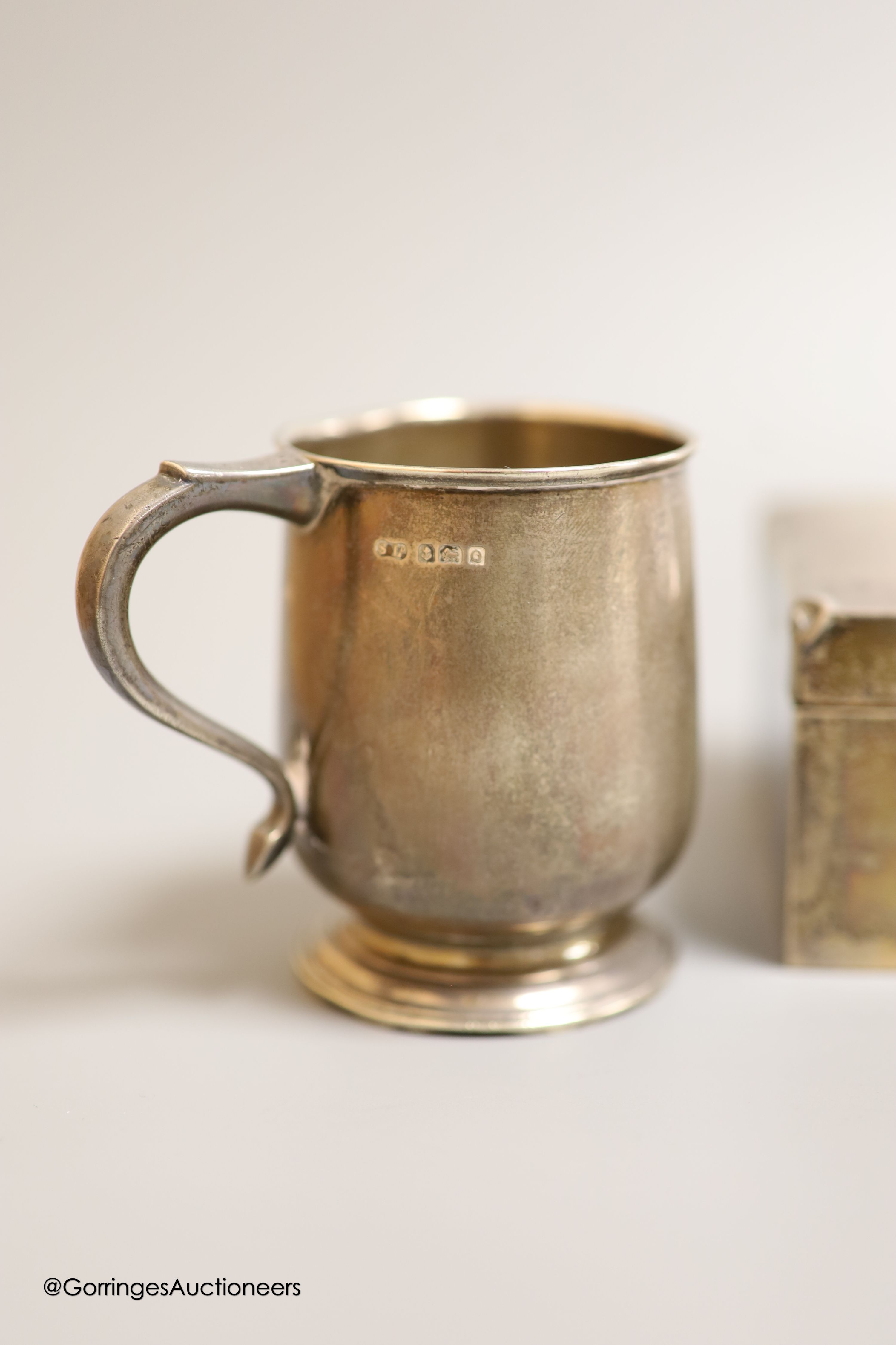 A George V silver rectangular cigarette box, Birmingham, 1926,16.5cm, a silver christening mug and a silver salt.